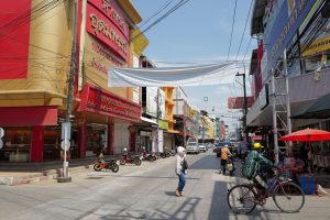 Lively urban street in Thailand with people, shops, and traffic under a sunny sky. — "Top Places to Buy Weed in Canada"